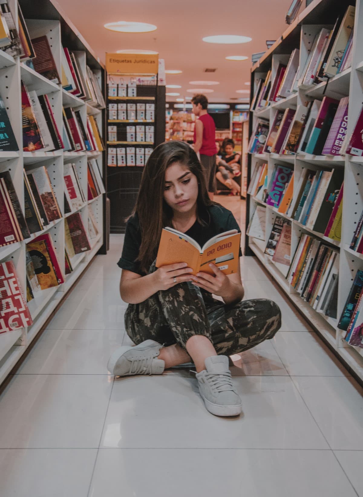 Fotografía de una chica estudiando en una librería.